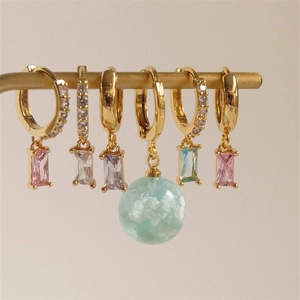 Row of gold hoop earrings featuring colorful zircon stones and mint green cloud ball charm