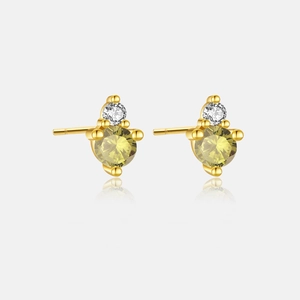 Detailed close-up of 925 silver gold-plated stud earrings with yellow birthstones