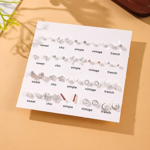 20 pairs of silver and gold pearl stud earrings featuring star and heart designs