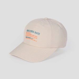 Close-up of beige nylon baseball cap with Success Rate typography and breathable eyelets
