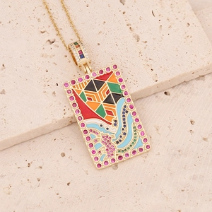 Macro shot of 18K gold tarot pendant with colorful enamel and micro-pave zircons