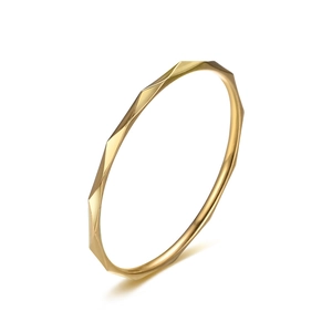 Detail view of 1mm gold-plated thin ring with geometric faceted texture