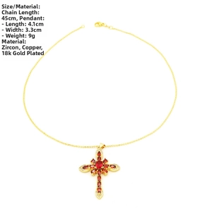 Detailed view of cross pendant measuring 4.1x3.3cm with red zircon and 18k gold plating