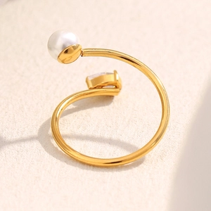 Macro view of 18K gold plated ring featuring white pearl and emerald cut cubic zirconia