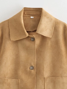 Close-up of brown suede jacket showing high-quality fabric texture and white size S neck tag