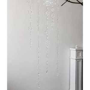 Transparent acrylic snowflake hanging ornaments for Christmas tree decor in home setting