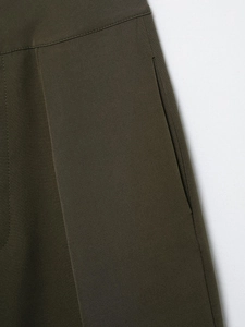 Detailed view of high-waisted olive green pants featuring side pockets and twill fabric