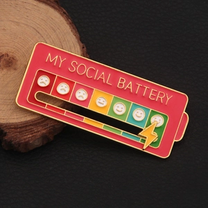 Interactive social battery enamel pin with sliding indicator on wood display stand