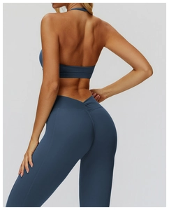 Detail of cross V-waist yoga leggings and backless sports bra in matte navy blue