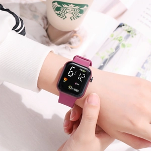 Detail of purple silicone strap LED sports watch with digital display on wrist