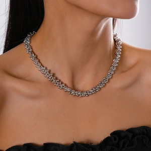 Close-up of silver beaded choker necklace showing polished metallic texture on neck