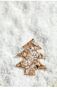 Close-up of wooden Christmas tree decor on white artificial snow background for scenery