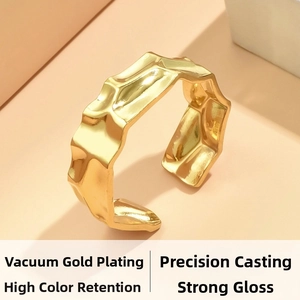 Macro detail of gold plated irregular hammered texture ring with high glossy finish
