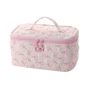 Floral quilted toiletry bag in light pink with star zippers and top handle