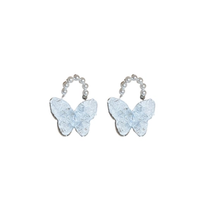 Light blue butterfly earrings with white pearls and silver needles on a white background