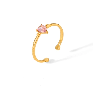 Detail of pink heart-shaped zircon ring with gold-plated textured band in a macro view