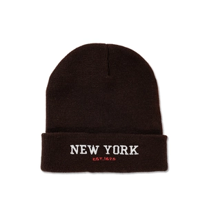 Detailed close-up of the New York EST. 1625 embroidery on a dark brown knit beanie hat