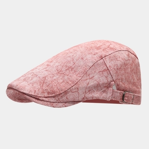 Detail of pink vintage wash newsboy cap featuring adjustable metal buckle side strap