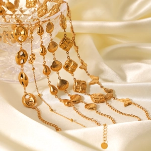 Detailed shot of 18K gold plated stainless steel necklaces with shell and butterfly charms