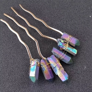 Detail of five gold U-shaped hairpins with colorful titanium-coated natural crystals