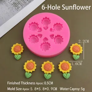 Detailed view of pink 6-hole sunflower silicone mold with finished floral resin pieces