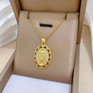 Detailed macro of gold oval pendant with portrait relief and sparkling zircon inlay