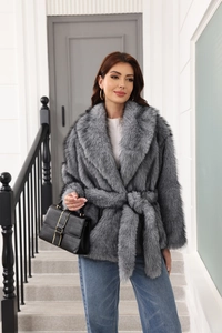 Detailed texture of grey faux fur coat featuring a matching belt and soft long sleeves