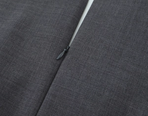 Detailed macro view of high-quality dark grey fabric texture with a hidden zipper closure