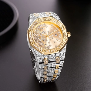 Macro shot of gold and silver luxury watch with diamond-encrusted octagonal bezel and dial