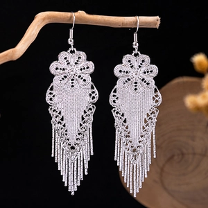 Vintage silver Bohemian floral drop earrings with long tassels on a branch