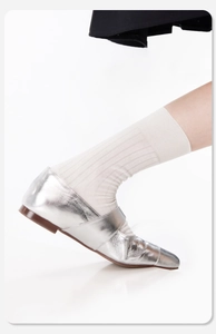 Detailaufnahme von silbernen Metallic-Lederflachschuhen mit quadratischer Spitze