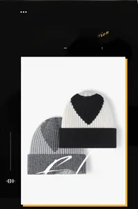 Close-up of thick rib-knitted hats featuring contrasting heart patterns and warm texture