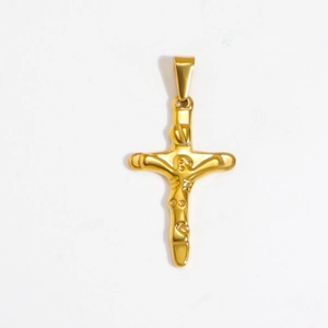 Macro shot of gold cross pendant with Jesus crucifix detail and polished finish