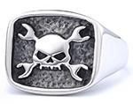 Close-up of vintage punk skull ring with cross wrenches in black and silver finish