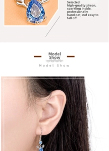 Macro detail of silver reindeer earring with blue pear-cut zircon and model ear wearing shot