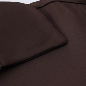 Detailed macro view of smooth satin fabric texture and premium stitching on dark brown shirt