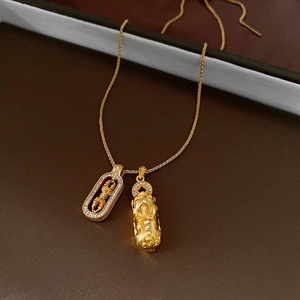 Macro shot of gold Pixiu and Vajra pendants with sparkling white zircon stones
