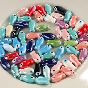 Colorful fish-shaped ceramic beads in various glossy glazes for DIY jewelry making