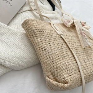 Large straw tote bag with cream leather straps and a chiffon floral bow decoration