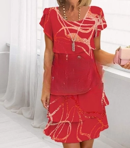 Red short sleeve dress with abstract prints and layered skirt design shown on model