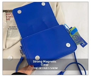 Detail view of deep blue PU leather bag featuring secure dual magnetic closures and strap