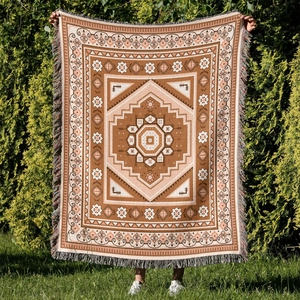 Detail of bohemian outdoor camping blanket with octagonal star pattern and colorful tassels