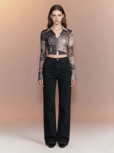 Front full view of high-waisted black wide-leg denim pants styled with a retro printed cardigan