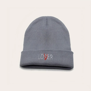 Grey knit beanie featuring LOVER embroidery with red V detail on light background