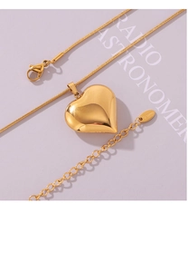Macro shot of 18k gold plated hollow heart pendant with S.steel engraved tag