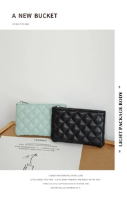 Close-up of quilted PU leather coin purses in mint green and black with diamond stitching