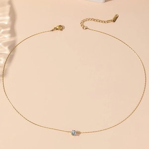 Minimalist gold titanium necklace featuring a sparkling white zircon solitaire pendant