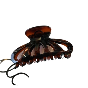 Large amber tortoise shell butterfly claw clip for elegant bun hairstyles on white background