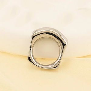 Minimalist silver irregular square ring on white geometric stand and silk background