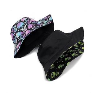 Double-sided reversible bucket hat featuring purple and green skull prints on white background